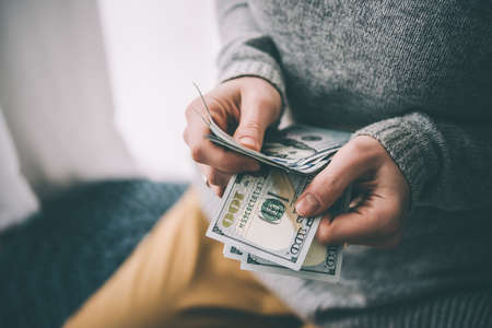 Hands counting us dollar bills. Toned pictureの写真素材
