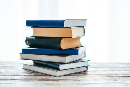 Pile of books on wooden table. Education and reading conceptの写真素材