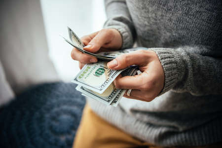 Hands counting us dollar billsの写真素材