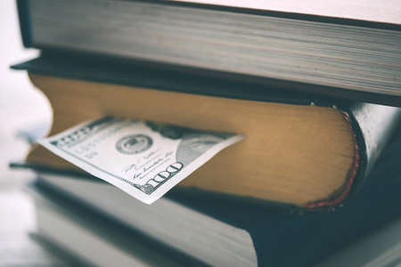 Pile of books and us dollar bill. Toned pictureの写真素材