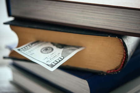 Pile of books and us dollar billの写真素材