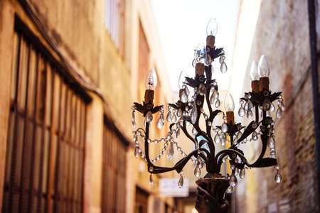 A beautiful chandelier is seen at one of the streets at Murano island, Venice, Italyの写真素材