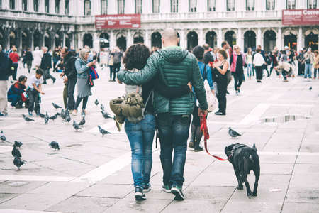 VENICE, ITALY - OCTOBER 12, 2015: A couple is walking at San Marco square in Venice, Italy. Toned pictureのeditorial素材