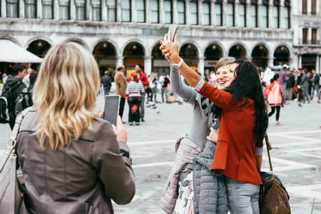 VENICE, ITALY - OCTOBER 12, 2015: Tourists are taking selfie at San Marco square in Venice, Italyのeditorial素材