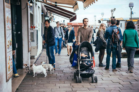 VENICE, ITALY - OCTOBER 11: People are walking in one of the streets in the centre of Venice, Italyのeditorial素材