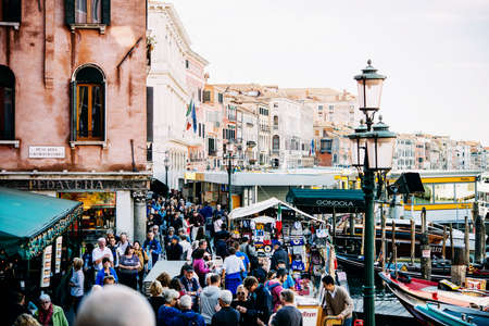 VENICE, ITALY - OCTOBER 12, 2015: A crowd of tourists walking along Grand Canal near Rialto bridge and vaporetto station in Venice, Italyのeditorial素材