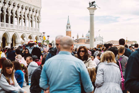 VENICE, ITALY - OCTOBER 12, 2015: A crowd of tourists is walking at San Marco square in Venice, Italyのeditorial素材