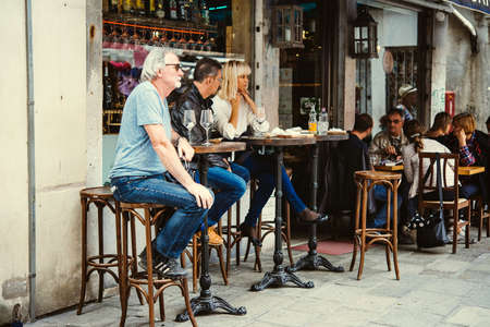 VENICE, ITALY - OCTOBER 11: People are sitting at the outside terrace of a small cafe in Venice, Italyのeditorial素材