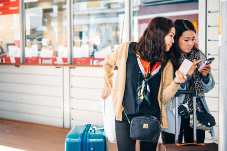 VENICE, ITALY - OCTOBER 12, 2015: Asian tourists are checking their way at Rialto vaporetto station in Venice, Italyのeditorial素材