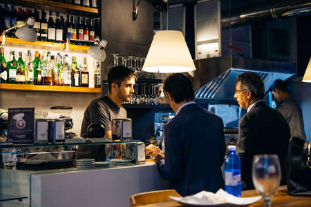 GENOA, ITALY - OCTOBER 8, 2015: People are ordering drinks in a bar in the historic centre of Genoa, Italyのeditorial素材