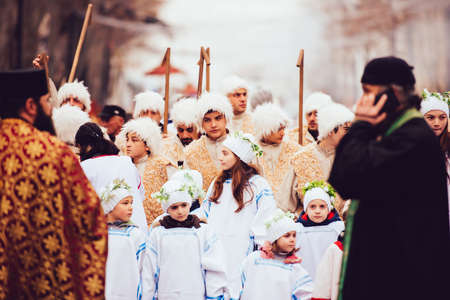 GEORGIA, TBILISI - JANUARY 7, 2016:  Men and children dressed as shepherds participate in Alilo, a religious procession to celebrate Orthodox Christmas in the centre of Tbilisi, Georgia. Toned in old film styleのeditorial素材
