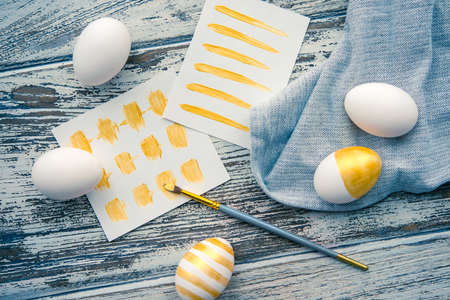 Modern easter eggs painted in gold. Toned pictureの写真素材