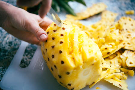 Close-up of pineapple cutting and carvingの写真素材