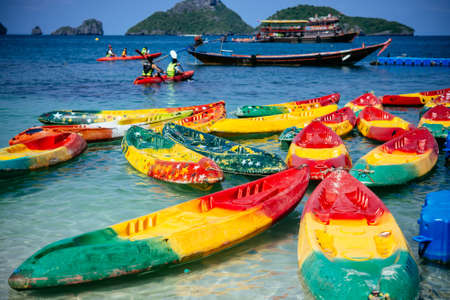 View of kayaking boats and fishing boats near one of the islands of Angthong national marine park in Thailandの写真素材