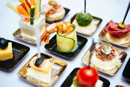 Different snacks and appetizers ready for a cocktail party. Catering concept.の写真素材