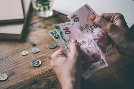 Hands holding turkish lira bills. Toned imageの写真素材