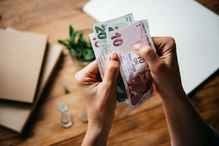 Hands holding turkish lira billsの写真素材