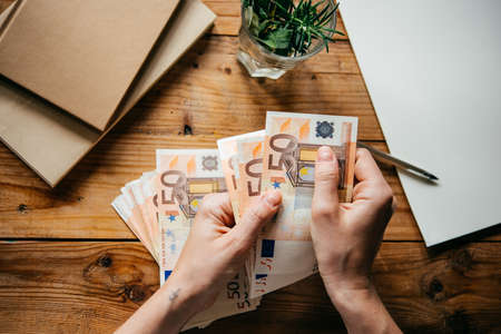 Hands holding european Euro billsの写真素材