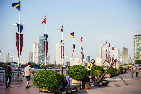 BANGKOK, THAILAND - MARCH 4, 2016: People walk along Chaophraya River embankment in one of business districts of Bangkok, Thailand.のeditorial素材
