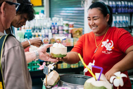 KOH SAMUI, THAILAND - MARCH 10, 2016: Street vendor sells coconut ice-cream in coconut shells at Koh Samui, Thailand.のeditorial素材