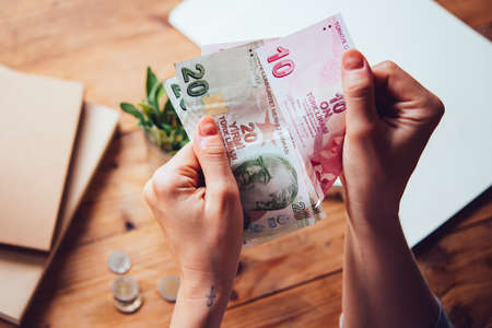 Hands holding turkish lira billsの写真素材