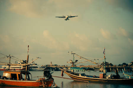 A plane is landing at Koh Samui airport, Thailand. Toned imageの写真素材