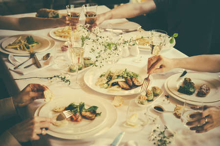 People are having lunch or dinner at a reastaurant. Toned imageの写真素材
