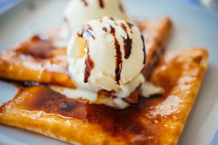 Pancakes with ice cream served on a white plateの写真素材