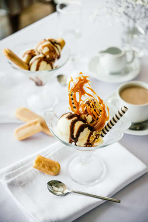 Ice cream with caramel and chocolate toppingの写真素材