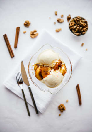 Ice cream with fried bananas, cinnamon and nutsの写真素材