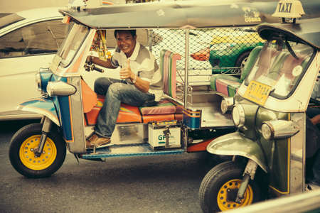 BANGKOK, THAILAND - FEBRUARY 26, 2016: Driver of traditional thai taxi called tuk-tuk in Bangkok, Thailand. Toned pictureのeditorial素材