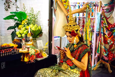 BANGKOK, THAILAND - FEBRUARY 26, 2016: A performer dressed in national thai clothes rests after the show in Bangkok, Thailand.のeditorial素材