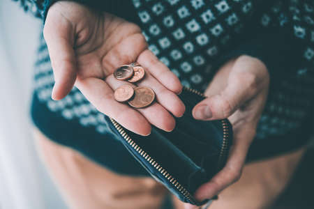 Hands holding euro cent coins and small money pouch. Toned pictureの写真素材