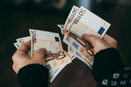 Hands holding euro billsの写真素材