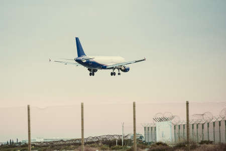 A plane landing at the airport. Toned imageの写真素材