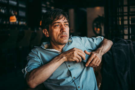 Portrait of a mature confident handsome man while thinkingの写真素材