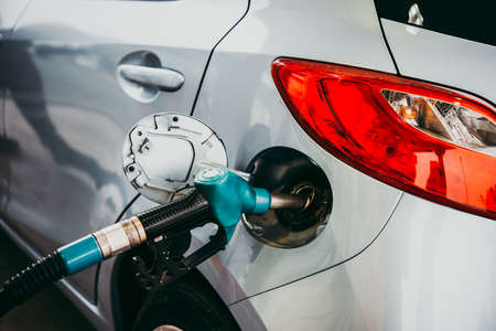 Fuel pump filling a car at a petrol station.の写真素材