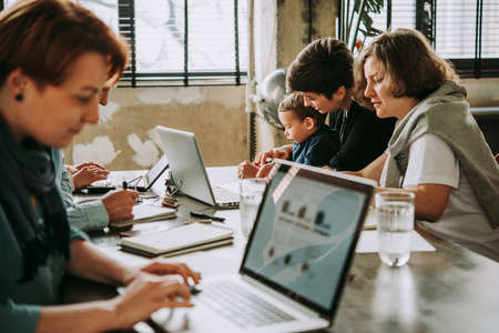 Young business women working together in creative coworking space