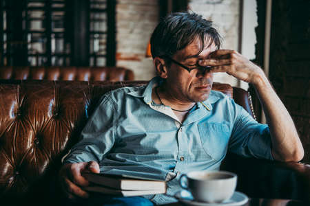 Mature handsome man feeling sad, tired or depressed.の写真素材