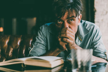 Mature handsome man feeling sad or depressed. Toned pictureの写真素材