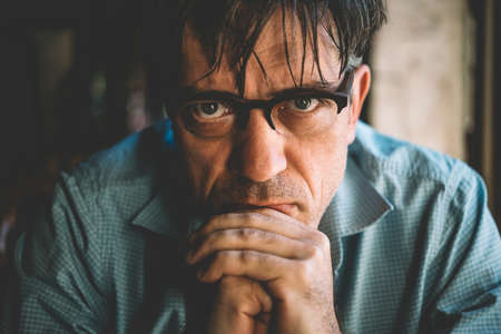 Portrait of a mature confident handsome man while thinking. Toned pictureの写真素材