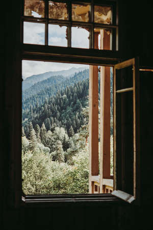 Summer field and mountains seen through the window in Racha region, Georgia, Caucasus.の写真素材