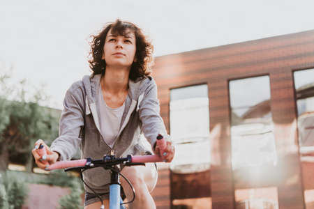 Portrait of a beautiful young girl with her single speed of fixed gear bicycle.の写真素材