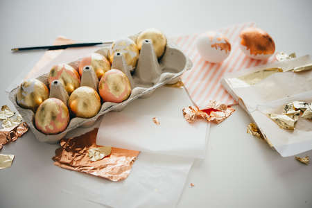 Modern style easter eggs in a box. Gold foil and pink acryllic pain hand made artの写真素材