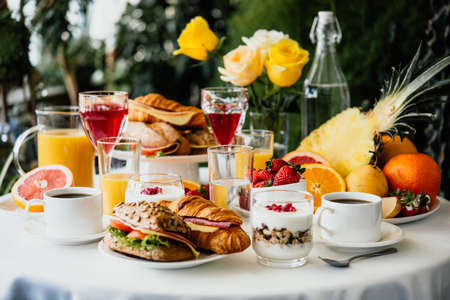 Healthy breakfast served with coffee, frouts and sandwichesの写真素材