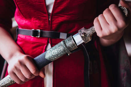 Girl wearing traditional georgian dress holding a dagger.の写真素材