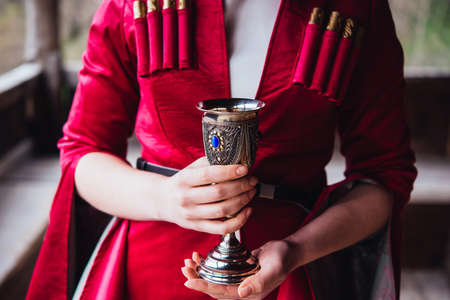 Hands holding a traditional georgian wine cupの写真素材