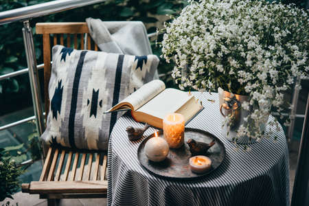 Beautiful terrace or balcony with small table, candles and flowersの写真素材