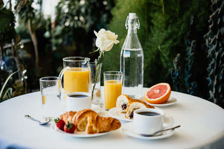 Continental breakfast served in a garden or cafeの写真素材