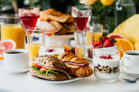 Healthy breakfast served with coffee, frouts and sandwichesの写真素材